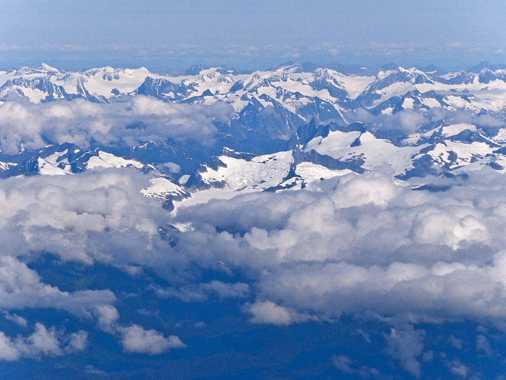 Aerial views of snow-capped mountains, ice fields, and glaciers on a commercial flight from Juneau to Anchorage Alaska, USA, Pacific Ocean