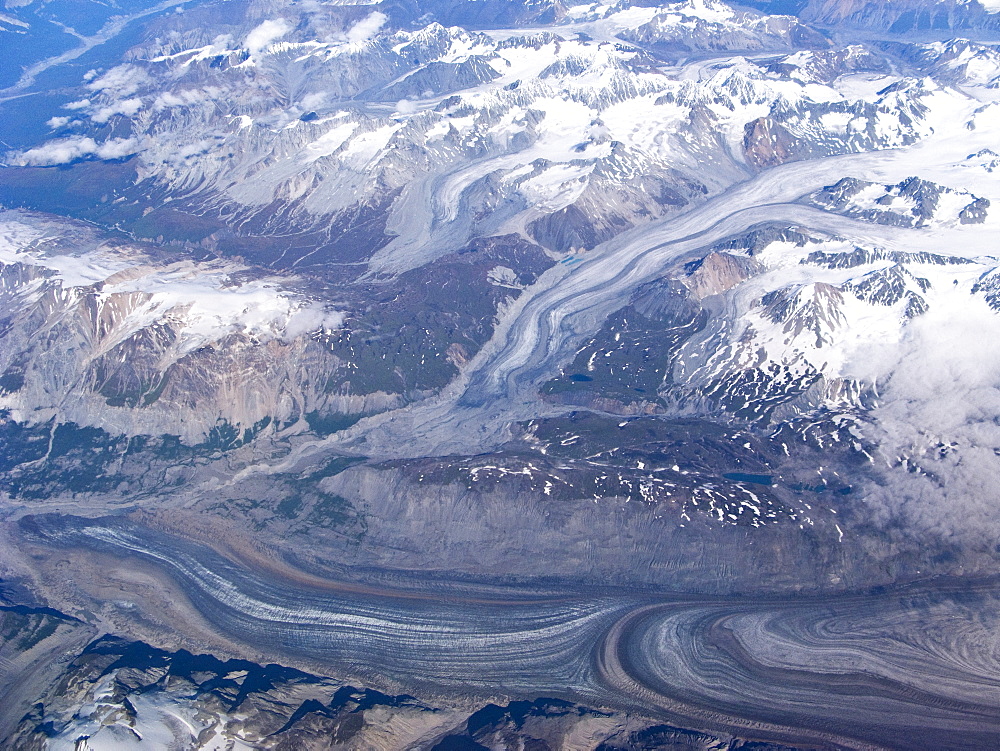 Aerial views of snow-capped mountains, ice fields, and glaciers on a commercial flight from Juneau to Anchorage Alaska, USA, Pacific Ocean