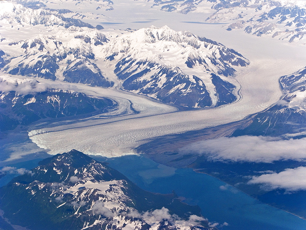 Aerial views of snow-capped mountains, ice fields, and glaciers on a commercial flight from Juneau to Anchorage Alaska, USA, Pacific Ocean