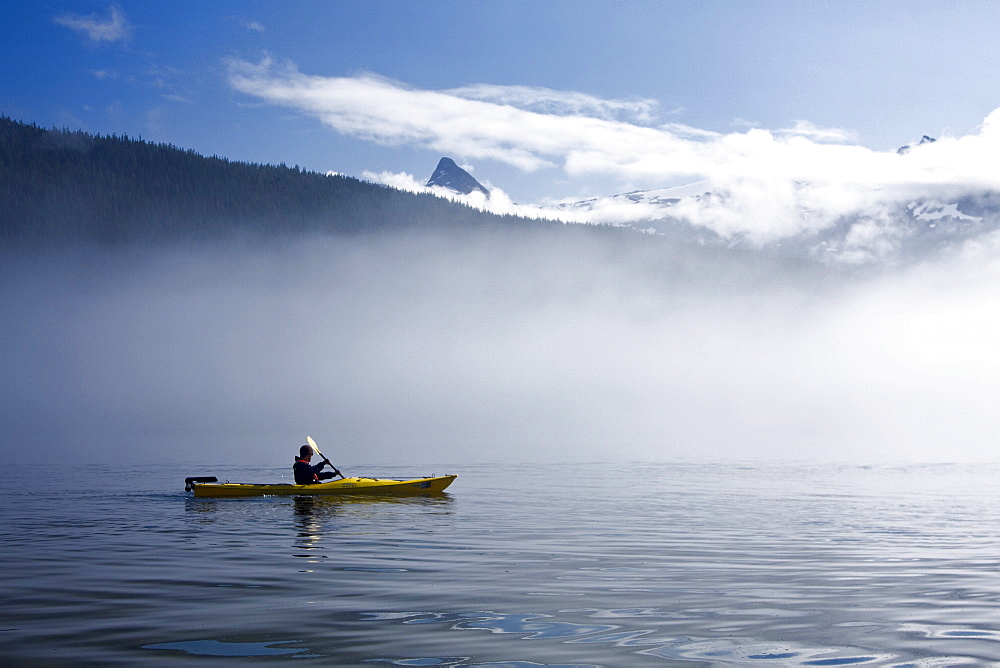 Kayaking from the Lindblad Expedition ship National Geographic Sea Lion in the fog in Tracy Arm in Southeast Alaska, USA. Pacific Ocean. No model or property release available for this photograph.