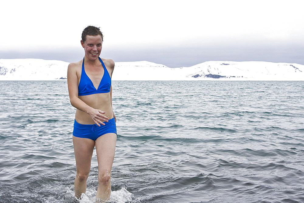 Lindblad Expeditions guests doing the "polar Plunge" in Port Foster near Whalers Bay inside the caldera on Deception Island, South Shetland Island Group, Antarctica. NO MODEL RELEASES FOR THIS IMAGE.