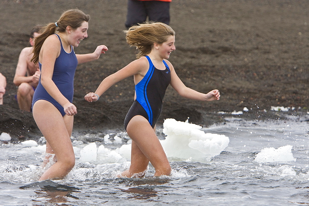 Lindblad Expeditions guests doing the "polar Plunge" in Port Foster near Whalers Bay inside the caldera on Deception Island, South Shetland Island Group, Antarctica. NO MODEL RELEASES FOR THIS IMAGE.