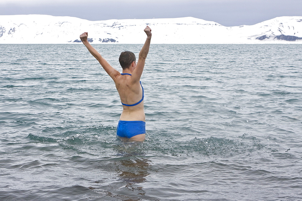 Lindblad Expeditions guests doing the "polar Plunge" in Port Foster near Whalers Bay inside the caldera on Deception Island, South Shetland Island Group, Antarctica. NO MODEL RELEASES FOR THIS IMAGE.