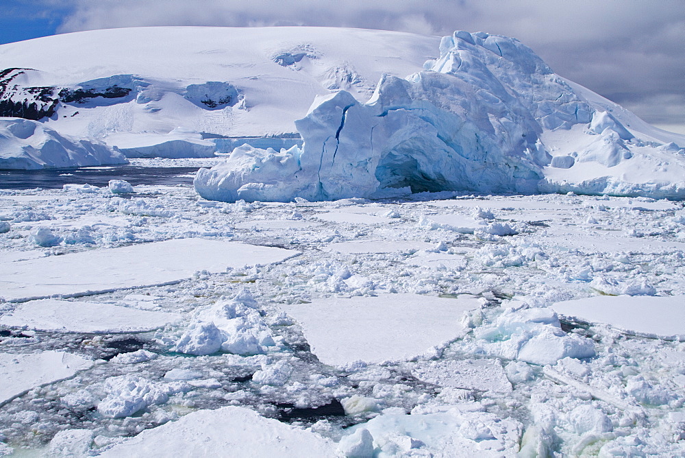 The Lindblad Expeditions ship National Geographic Explorer pushes through ice in Crystal Sound, south of the Antarctic Circle, Antarctica, Southern Ocean