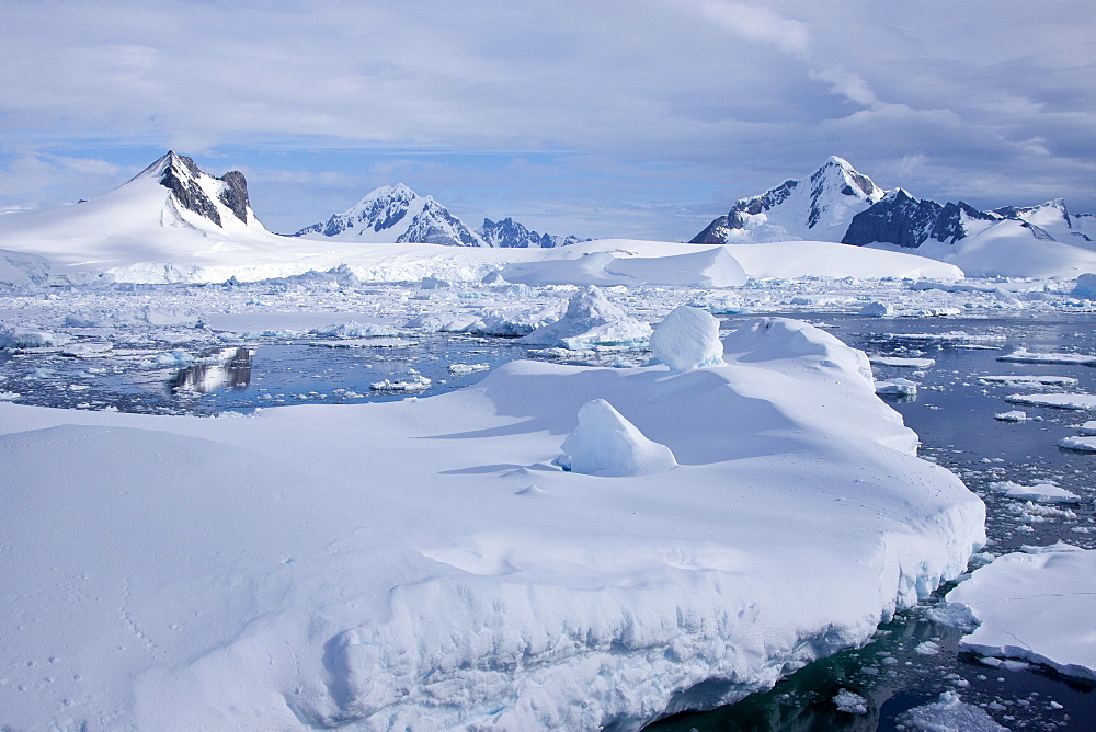 The Lindblad Expeditions ship National Geographic Explorer pushes through ice in Crystal Sound, south of the Antarctic Circle, Antarctica, Southern Ocean