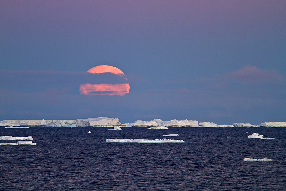 Full moon (plus 1 day) rising over icebergs in the Weddell Sea, Antarctica. MORE INFO This moonrise occurred on January 1, 2010, the night after the blue moon full of December 31, 2009.