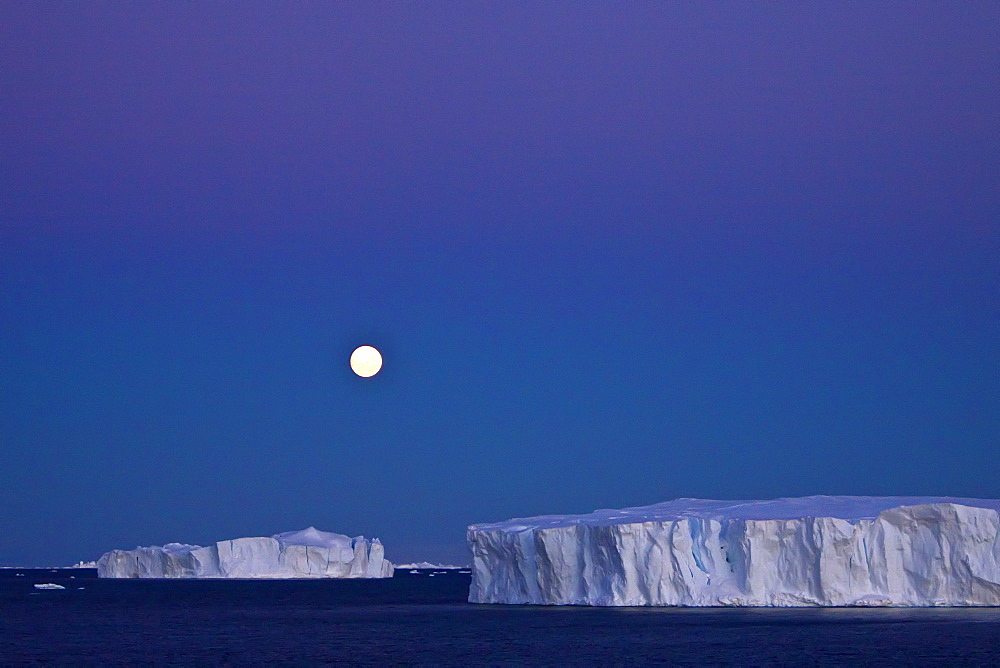 Full moon (plus 1 day) rising over icebergs in the Weddell Sea, Antarctica. MORE INFO This moonrise occurred on January 1, 2010, the night after the blue moon full of December 31, 2009.