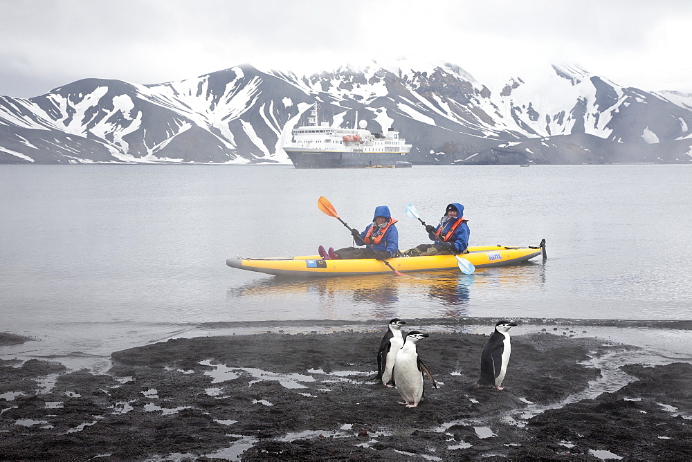 Guests from the Lindblad Expedition ship National Geographic Explorer kayaking in and around the Antarctic Peninsula in the summer months. 