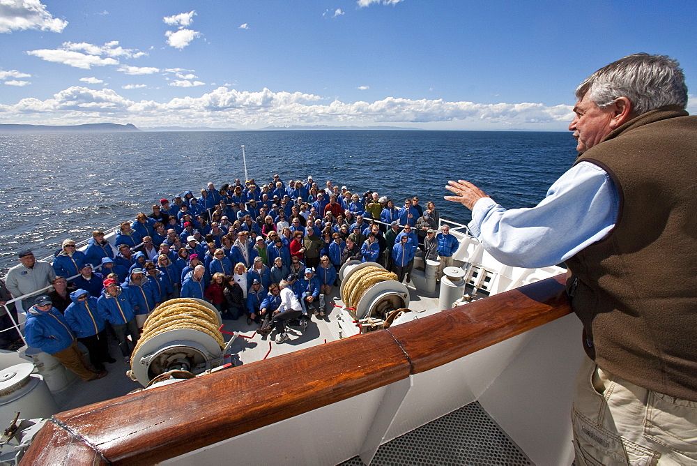 Exclusive Resorts guests from the Lindblad Expedition ship National Geographic Explorer pose for a photo on the bow