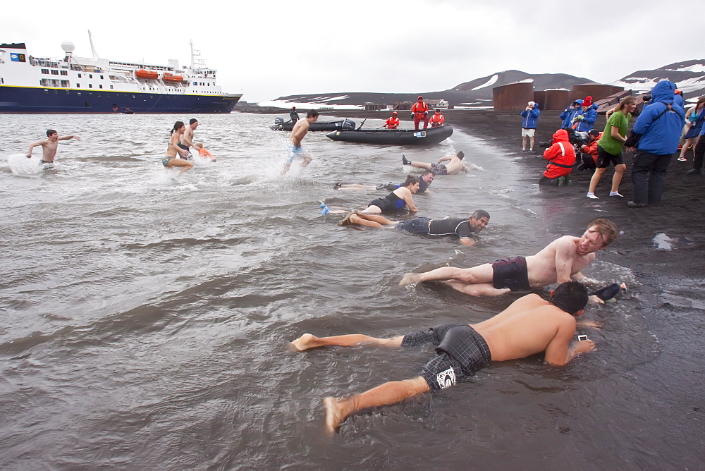 Guests from the Lindblad Expedition ship National Geographic Explorer lay in the relatively warm waters of the caldera at Deception Island, South Shetland Islands, Antarctica