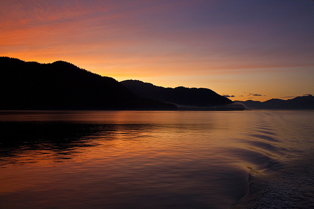 Sunset from the stern of the Lindblad Expeditions ship National Geographic Sea Bird in Lynn Canal, Southeast Alaska, USA.