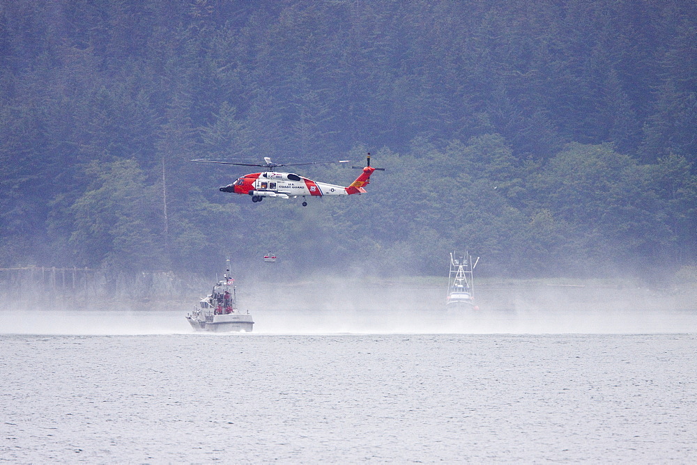 U.S. Coast Guard helicopter performing a rescue operation in Southeast Alaska, USA, Pacific Ocean.