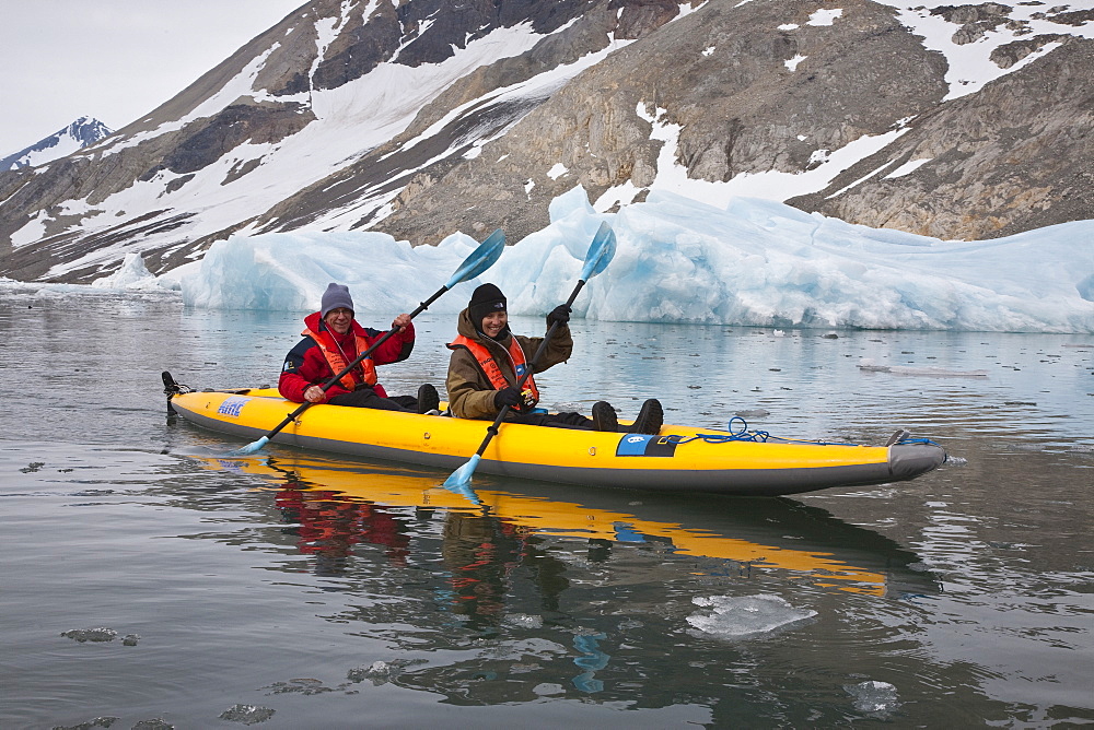 Guests from the Lindblad Expedition ship National Geographic Explorer kayaking near Monaco Glacier on Spitsbergen Island in the Svalbard Archipelago in the summer months. 