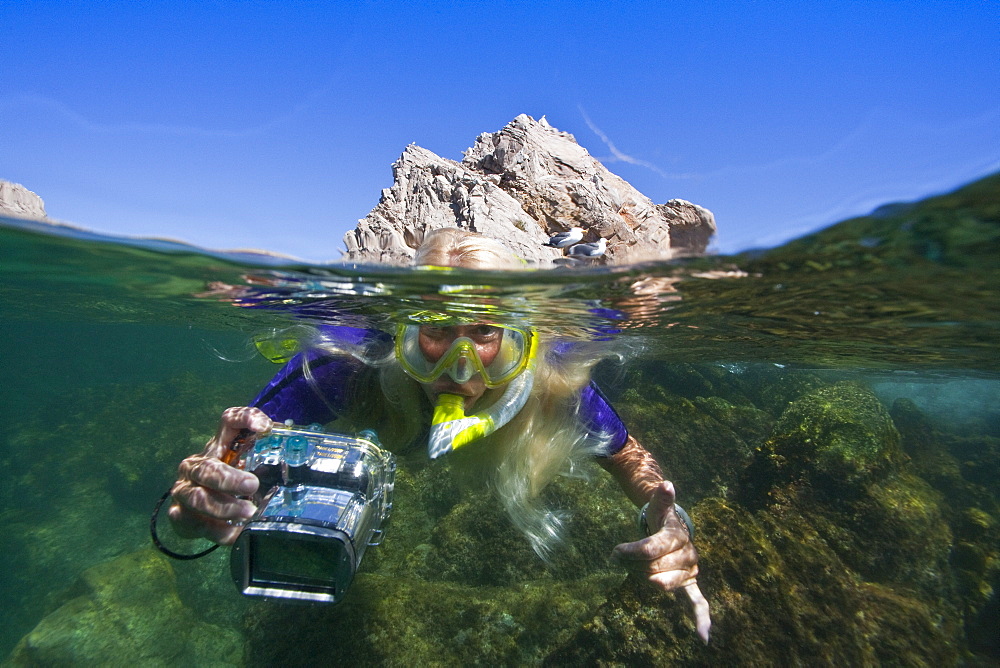 Where the desert meets the sea; a snorkeler at Isla Santa Catalina in the Gulf of California (Sea of Cortez), Baja California Sur, Mexico