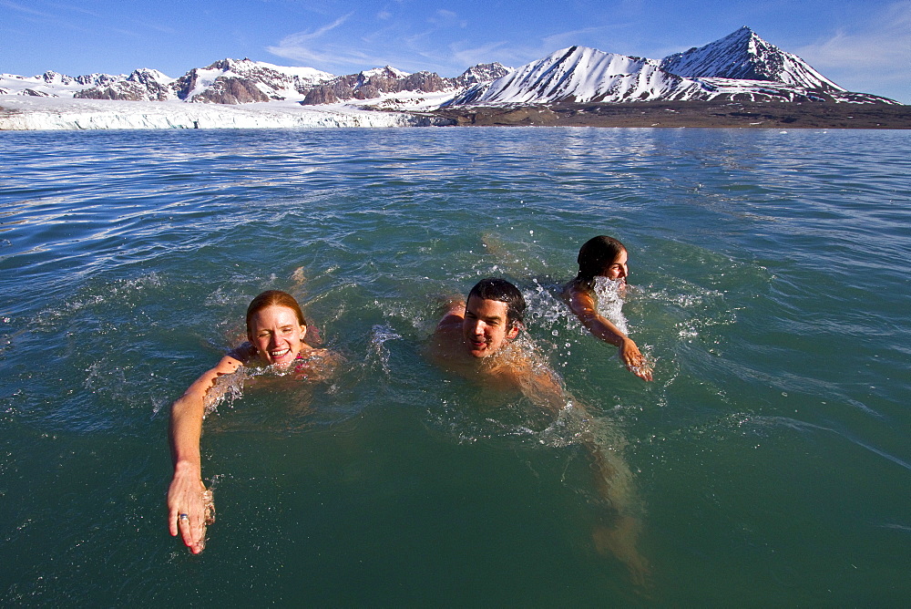 Guests from the Lindblad Expedition ship National Geographic Explorer taking the "polar plunge" in the Svalbard Archipelago, Norway