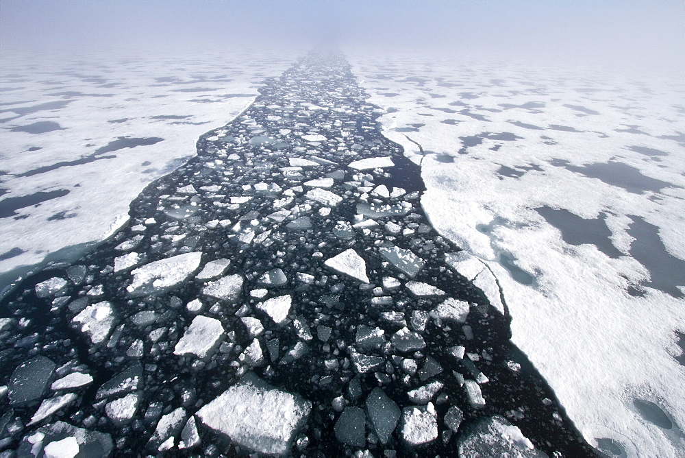 The Lindblad Expedition ship National Geographic Explorer breaking through ice in the Svalbard Archipelago, Norway