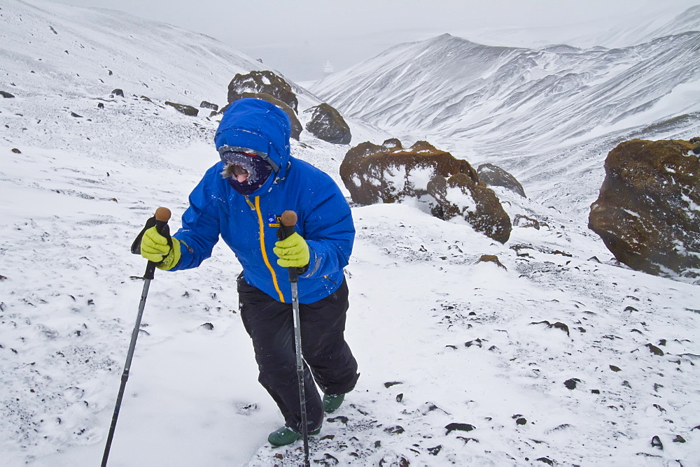 Guests from the Lindblad Expedition ship National Geographic Explorer during snowstorm at Deception Island in Antarctica