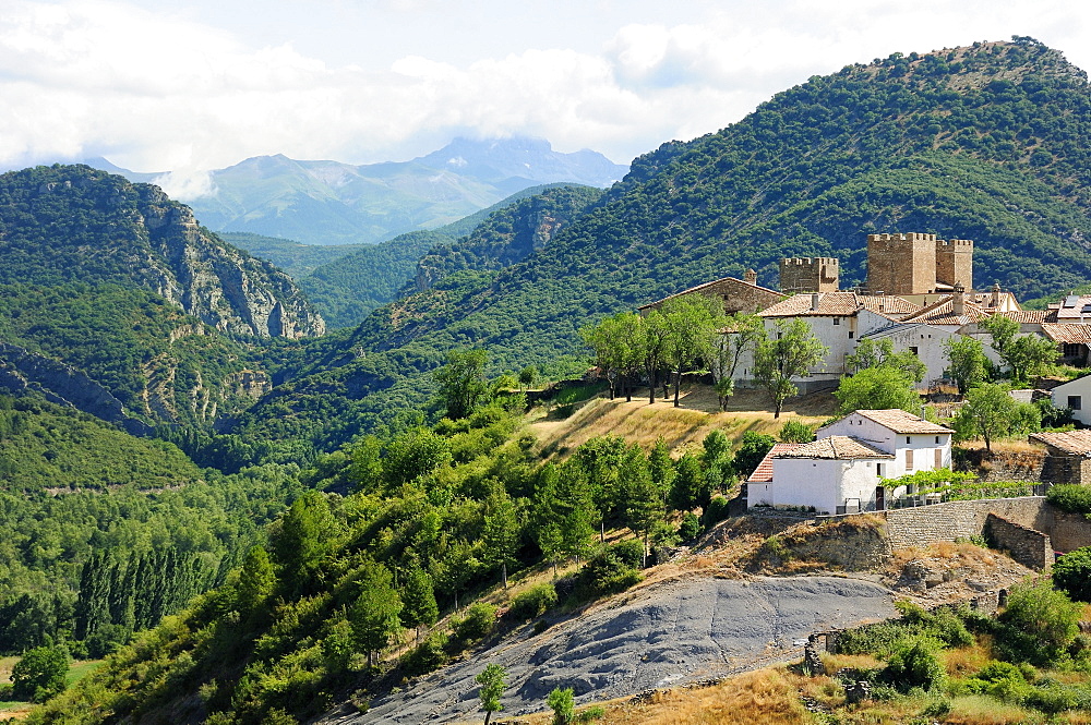 Binies village and castle with Foz de Binies gorge, Anso valley and Pyreneean peaks in the background, Huesca, Aragon, Spain, Europe