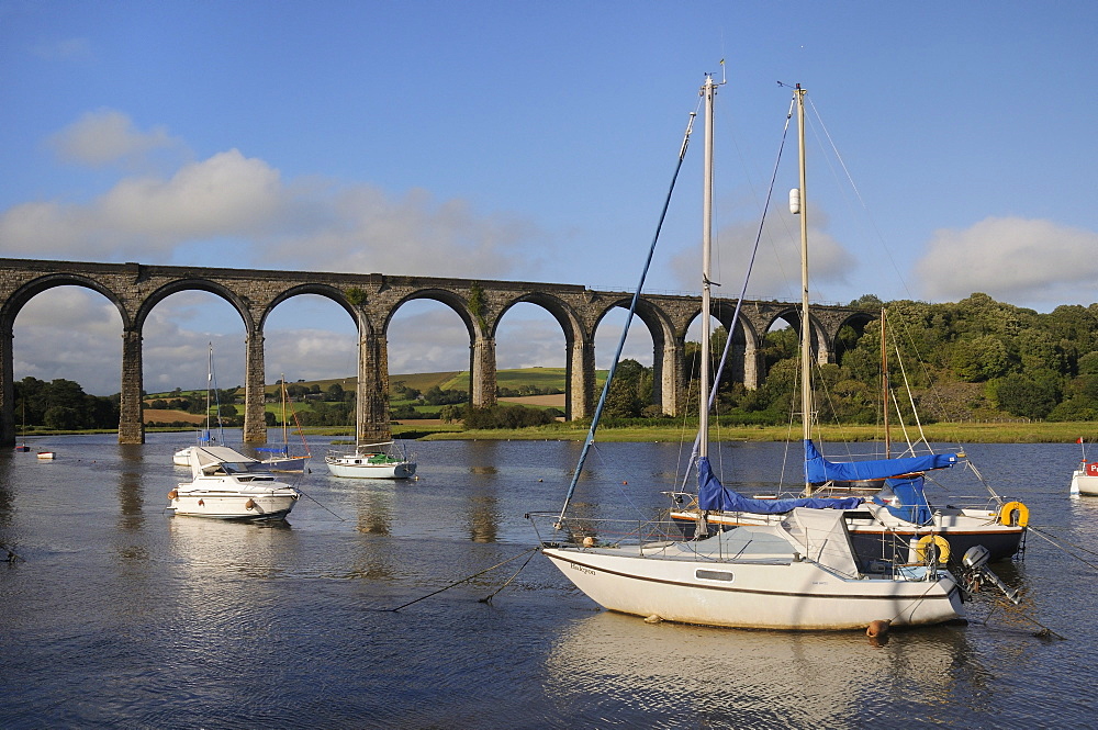 Sailing yachts moored in the River Lynher at high tide below St. Germans railway viaduct, Cornwall, England, United Kingdom, Europe