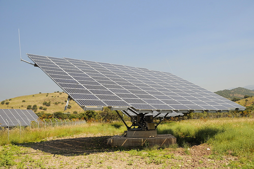 Photovoltaic solar tracker at a solar farm near Antissa, Lesbos (Lesvos), Greece. MORE INFO: Solar trackers automatically rotate and tilt photovoltaic panels to follow the sun throught the day, maximising sunlight absorpton rates. Several of these Solar farms have been built on Lesbos since 2010.