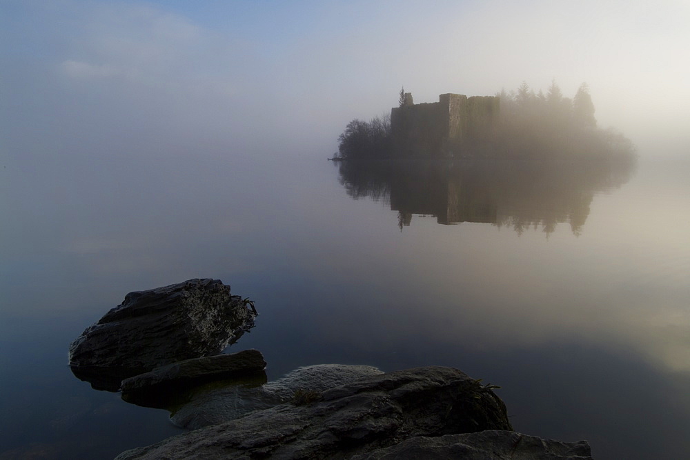 Innischonnell castle on Loch, misty morning rocks in foreground, Argyll, Scotland.  Argyll, Scotland