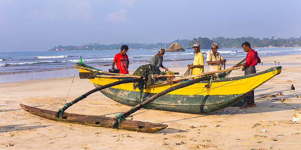 Fishermen sorting their catch on Weligama Beach, South Coast of Sri Lanka, Asia 