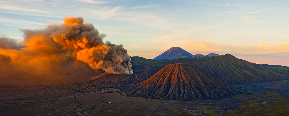 Mount Bromo (Gunung Bromo), an active volcano, erupting at sunrise throwing up ash clouds, East Java, Indonesia, Southeast Asia, Asia