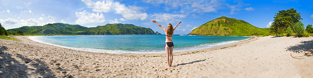 Woman enjoying freedom at Mawun Beach, a tropical paradise in South Lombok, Indonesia, Southeast Asia, Asia