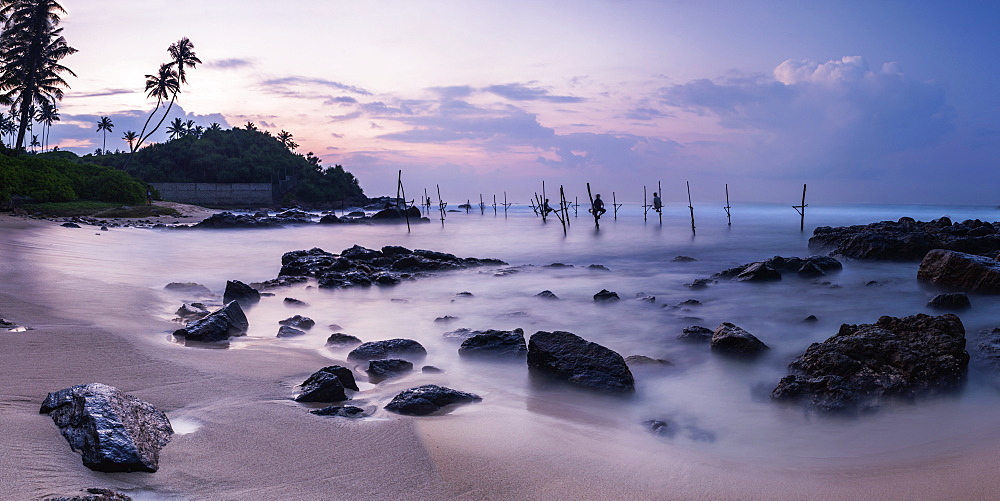 Stilt fishermen at sunrise, Midigama near Weligama, South Coast, Sri Lanka, Indian Ocean, Asia