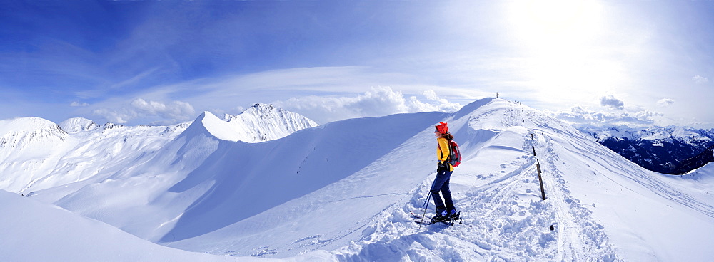 Female backcountry skier at Kreuzeck enjoying view, Radstaedter Tauern, Niedere Tauern, Salzburg, Austria