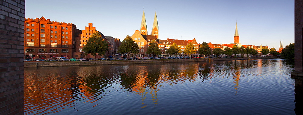 Panoramic view over the Trave river to the old town of Luebeck with old storehouses at the Holsten harbour, St MaryÂ¥s church and church of St Petri, Hanseatic city of Luebeck, Baltic Sea, Schleswig-Holstein, Germany