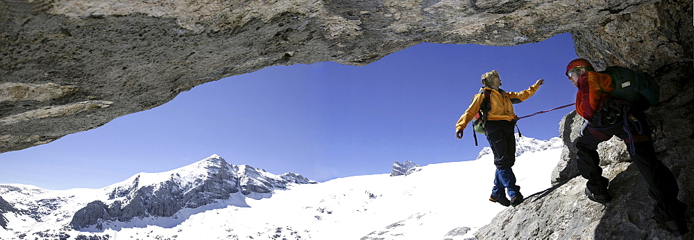 Two mountain climbers in a cave at Schoberl, Hallstaetter Glacier, Dachstein, Austria