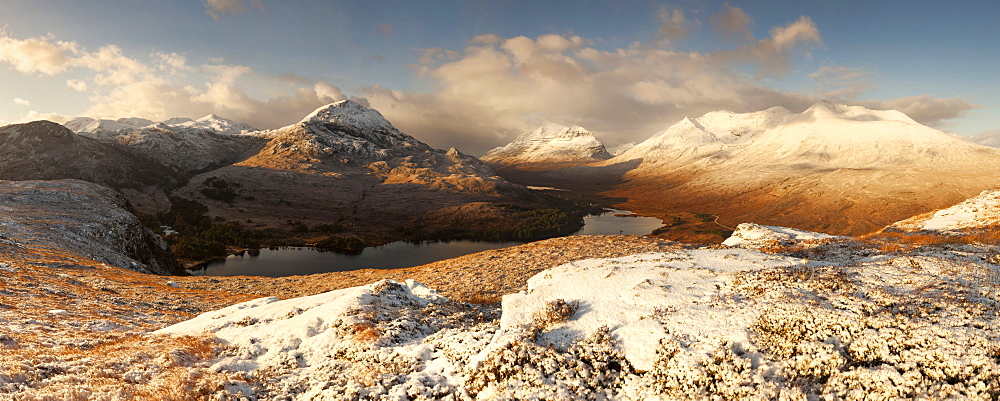 Vast panorama of the snow-covered North West Highlands overlooking the summits of Sgurr Dubh, Liathach and Beinn Eighe (from left) over the Loch Clair in winter, Scotland, United Kingdom