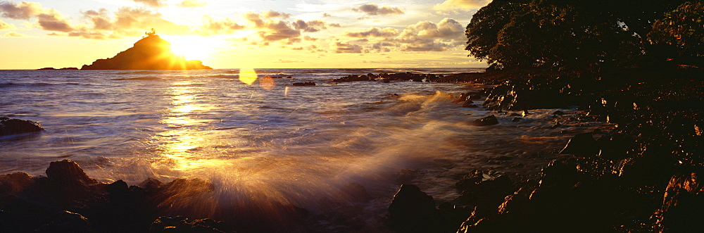 Hawaii, Maui, Hana, View of sunrise bursting over Alau Island from Hana shoreline.