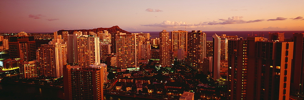 Hawaii, Oahu, Waikiki, Evening glow on city buildings at twilight.