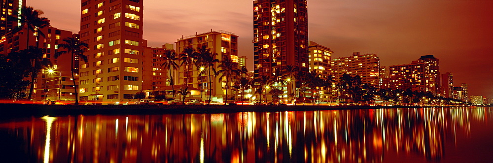 Hawaii, Oahu, Waikiki at dusk, Glow of city lights on Ala Wai Canal.