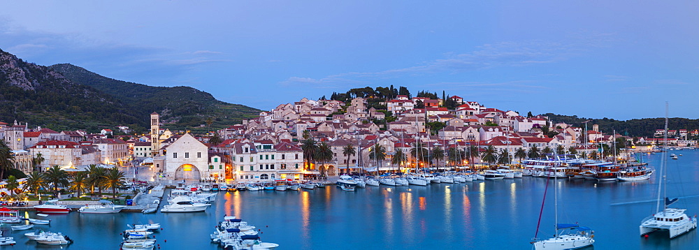 Elevated view over the picturesque harbour town of Hvar illuminated at dusk, Hvar, Dalmatia, Croatia, Europe