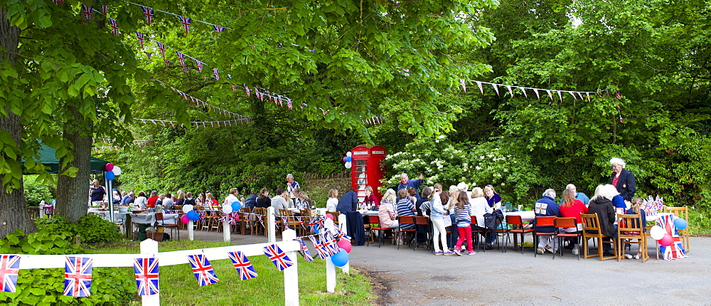 Street party with Union Jack flags and bunting to celebrate Queen's Diamond Jubilee at Swinbrook in The Cotswolds, UK