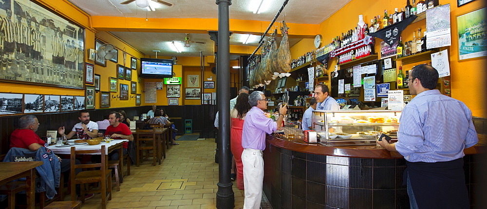 Locals in traditional Spanish Tapas Raciones bar in Bilbao, Spain