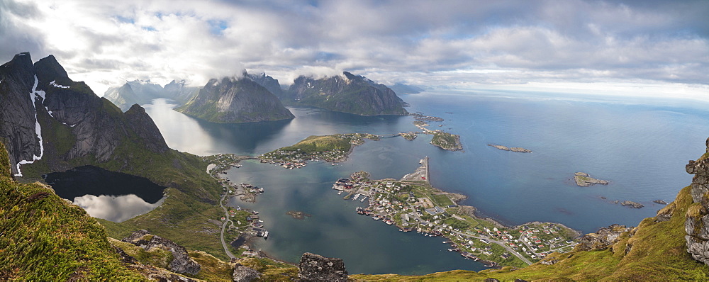 Panorama of the blue lake and sea framed by rocky peaks, Reinebringen, Moskenesoya, Lofoten Islands, Norway, Scandinavia, Europe