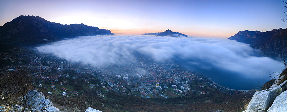 Panoramic of fog at sunrise above the city of Lecco seen from Monte San Martino, Province of Lecco, Lombardy, Italy, Europe