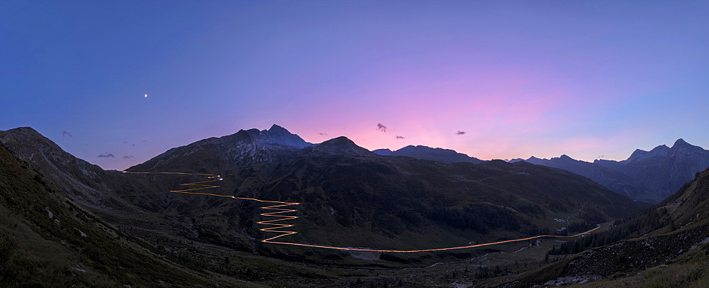 Panoramic of lights of car traces at sunset, Spluga Pass, Chiavenna Valley, Switzerland, Europe