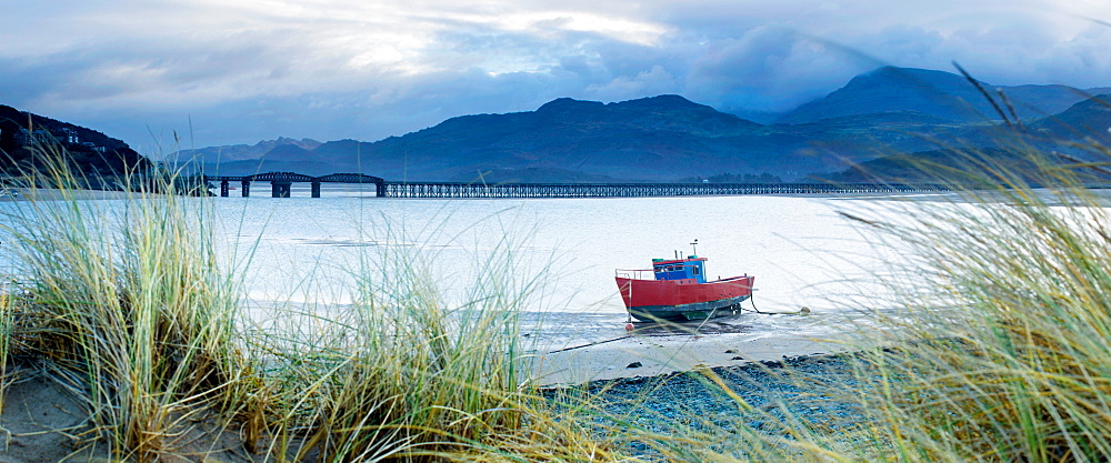 Fishing boat with Barmouth Bridge in background, coast of Cardigan Bay, Gwynedd, Wales, United Kingdom, Europe