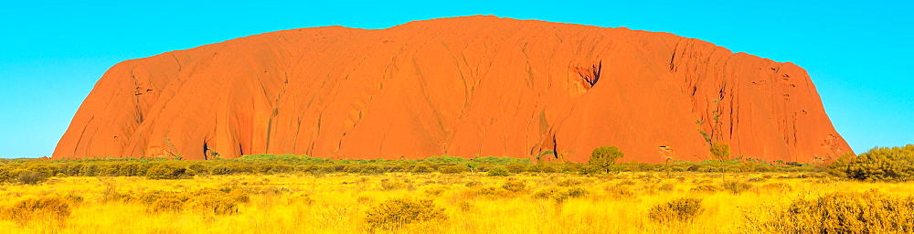 Banner panorama of majestic Uluru (Ayers Rock), the huge sandstone monolith in Uluru-Kata Tjuta National Park, icon of Australian outback or Red Centre, UNESCO World Heritage Site, Northern Territory, Australia, Pacific