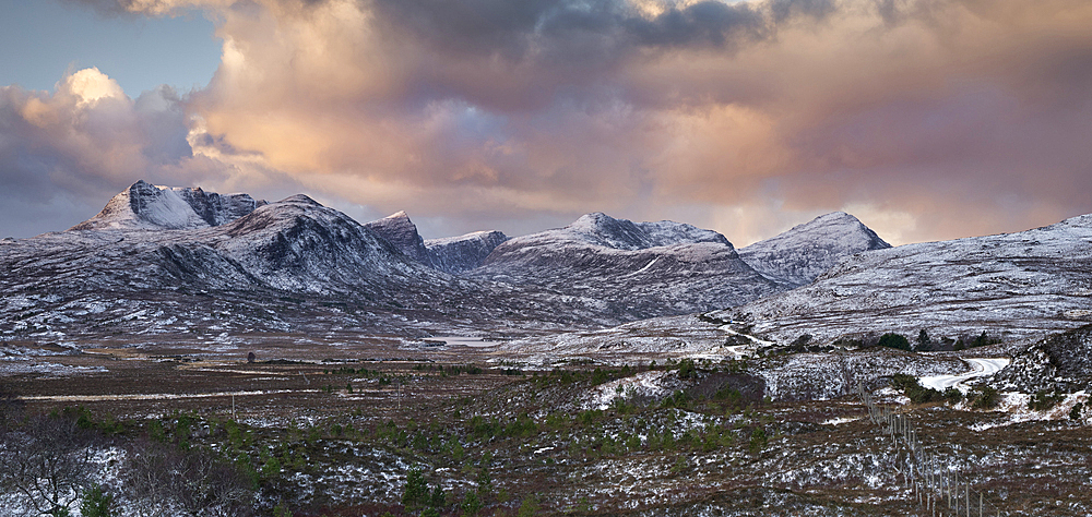 Sunrise over the mountains of Assynt in winter, Ben Mor Coigach, Beinn Tarsuinn, Sgurr an Fhidhleir, Beinn an Eoin and Sgorr Tuath with Lochan Tuath below, Assynt, Assynt-Coigach National Scenic Area, Sutherland, Scottish Highlands, Scotland, United Kingdom, Europe