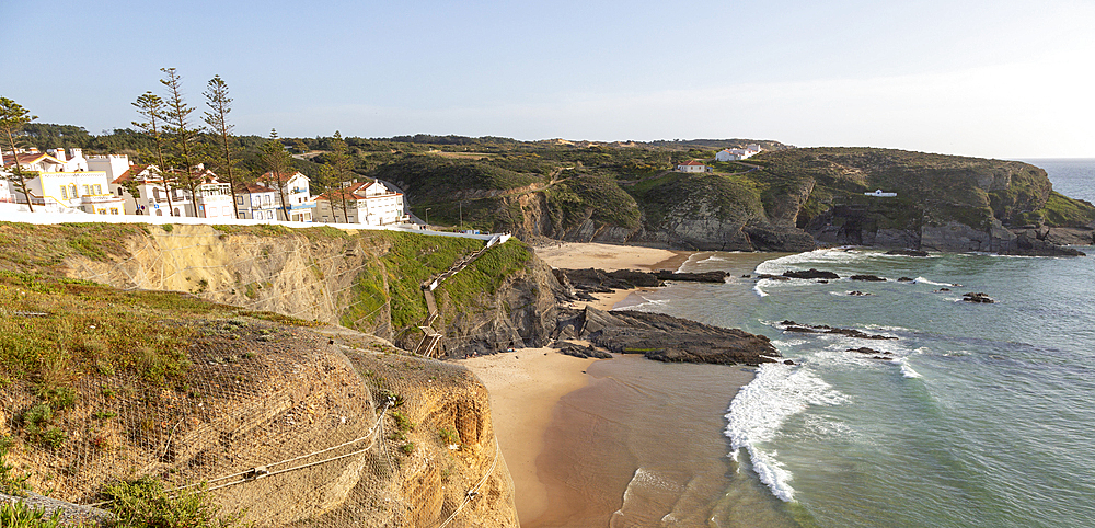 Sandy beach in bay between rocky headlands part of Parque Natural do Sudoeste Alentejano e Costa Vicentina, Zambujeira do Mar, Alentejo Littoral, Portugal, Europe