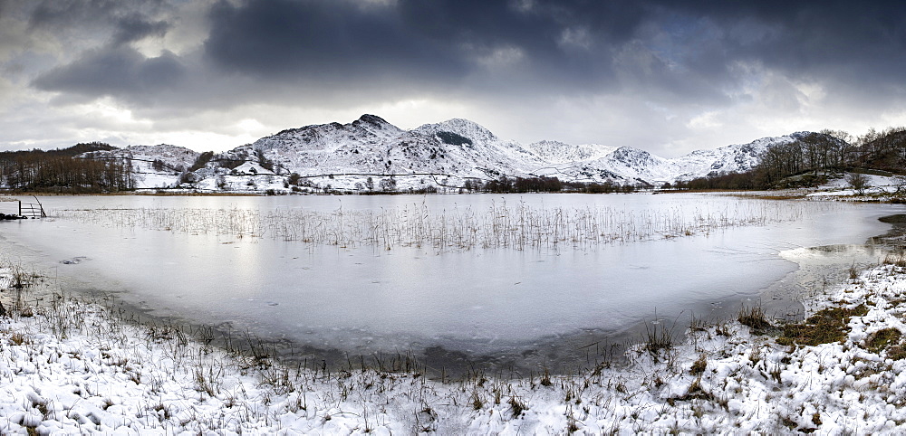 Frozen Little Langdale Tarn and snow-covered fells, near Ambleside, Lake District National Park, Cumbria, England, United Kingdom, Europe