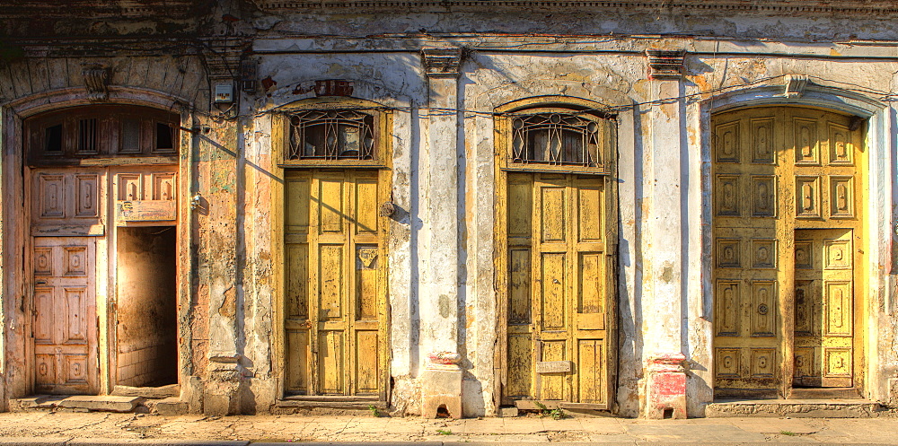 Facades of dilapidated colonial buildings bathed in evening light, Havana, Cuba, West Indies, Central America