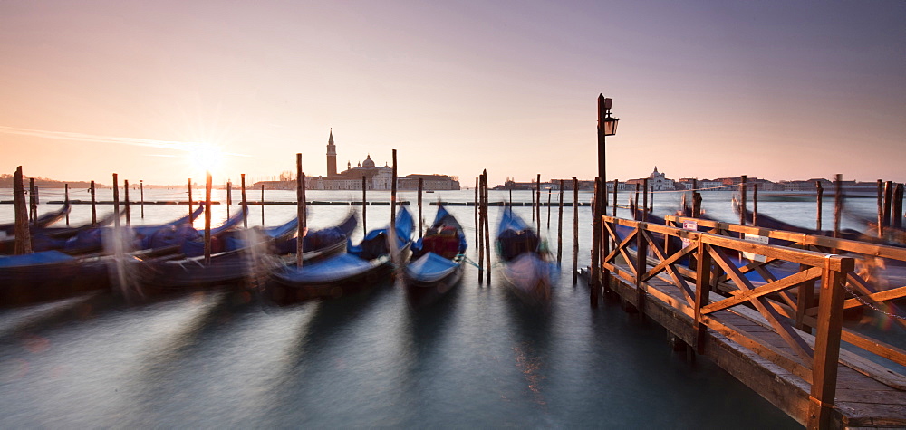 View towards San Giorgio Maggiore at dawn from Riva Degli Schiavoni, with gondolas in foreground, Venice, UNESCO World Heritage Site, Veneto, Italy, Europe