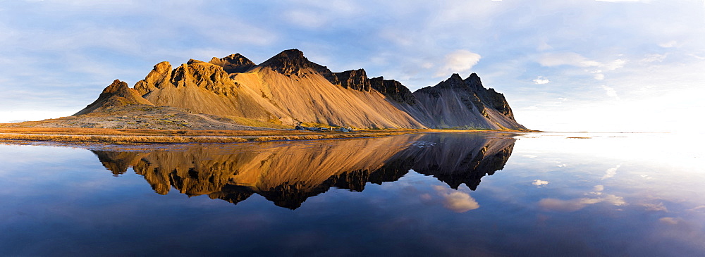 Panoramic view of mountains of Vestrahorn and perfect reflection in shallow water, soon after sunrise, Stokksnes, South Iceland, Polar Regions